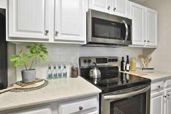 a kitchen with white cabinets and a black stove top oven at Crestmont at Thornblade, Greenville, South Carolina